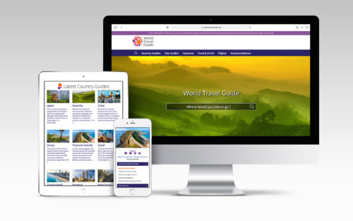 A computer screen, ipad and phone feature various pages of the World Travel Guide website